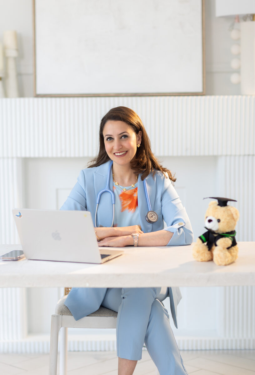 Dr. Farah Siam at her desk with stethoscope